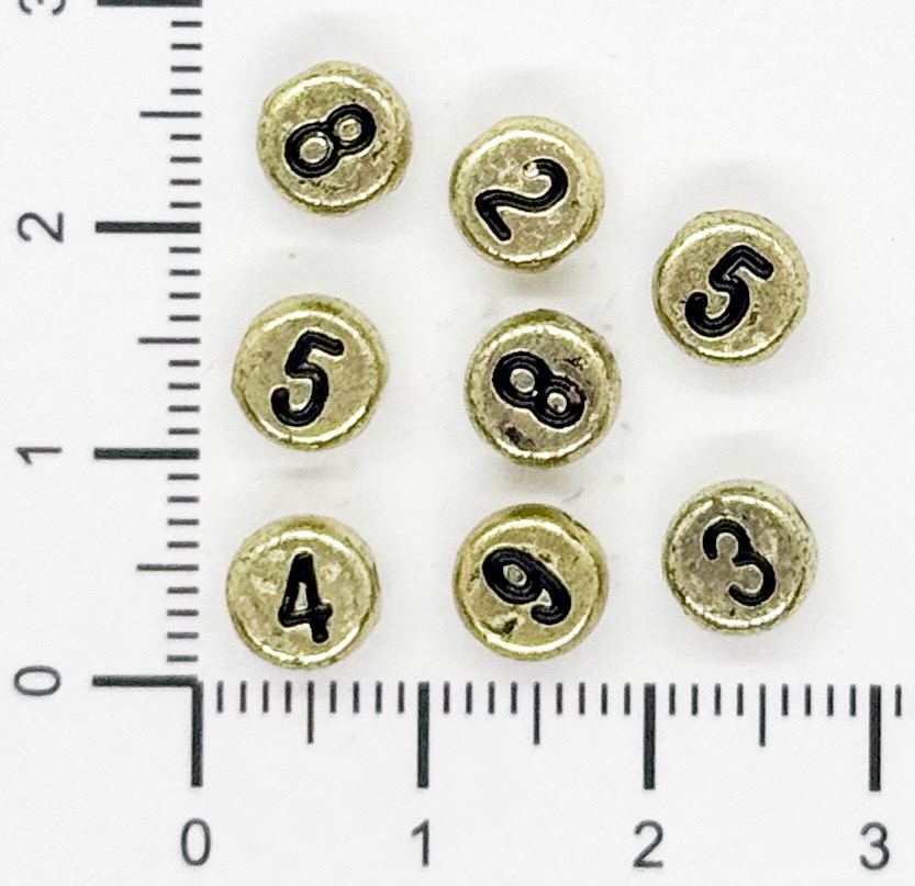 Plástico números plano 7mm dorado x 10 grs.